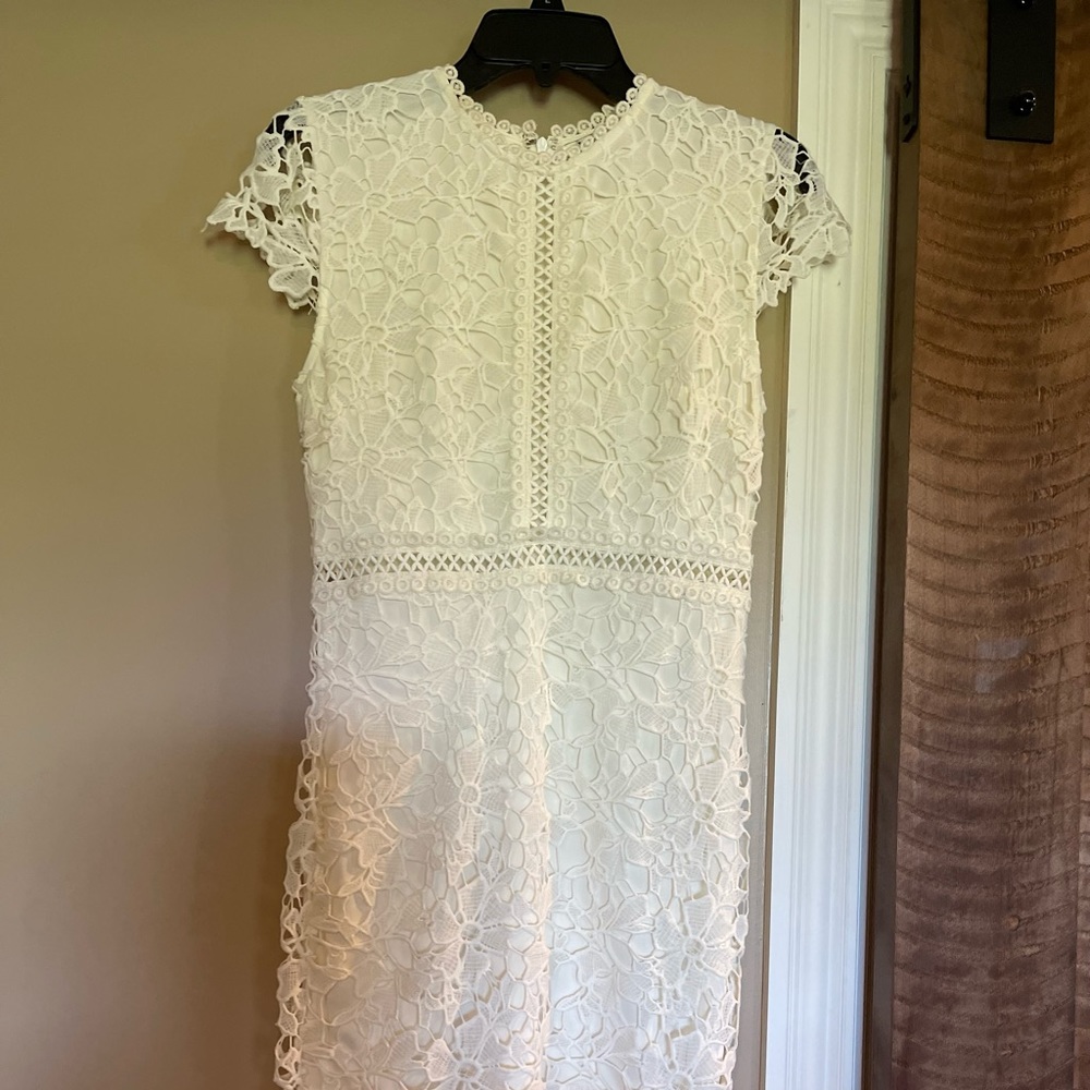 White lace overlay dress. Bought from a boutique. Never worn. Size S.